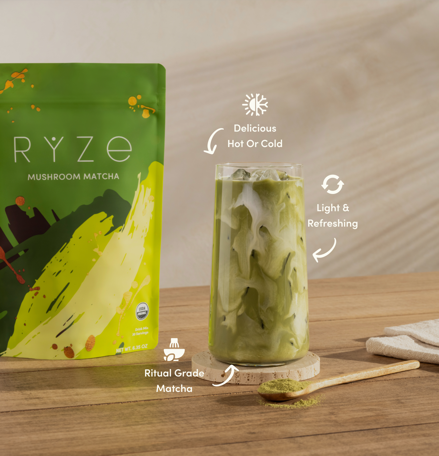 Iced coffee with cream swirls beside a Ryze mushroom coffee package on a kitchen counter.